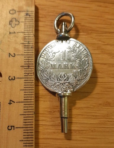 Uhrenschlüssel mit münze - uhrenschlüssel,